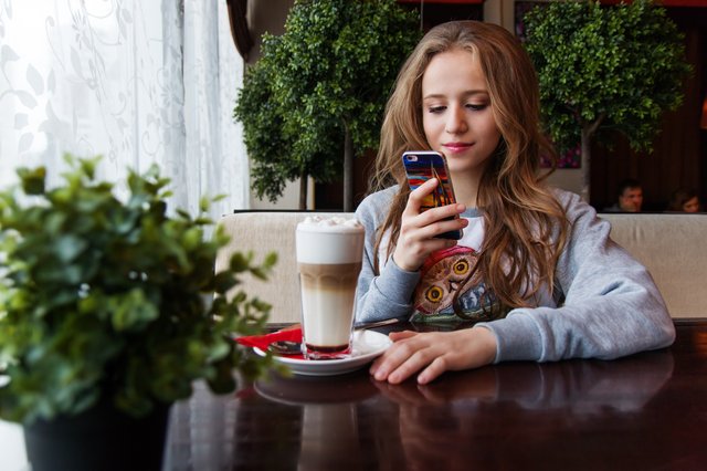 teen on phone with coffee