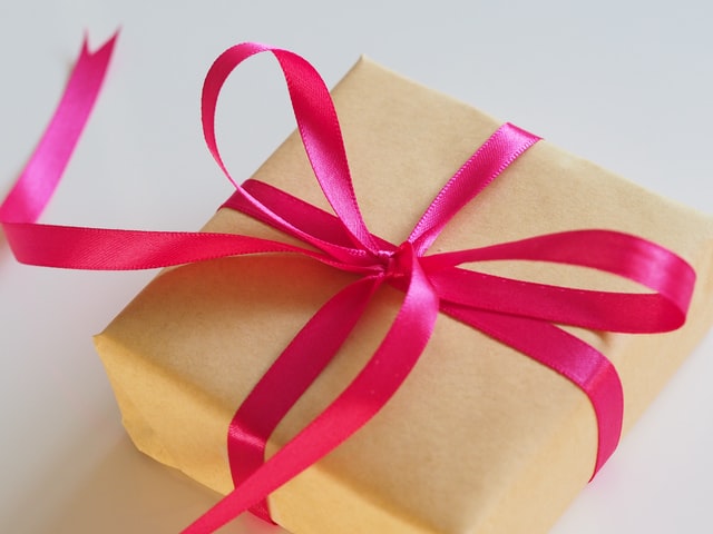 brown gift box with red ribbon