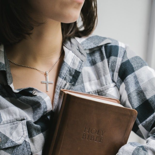 teen girl holding bible