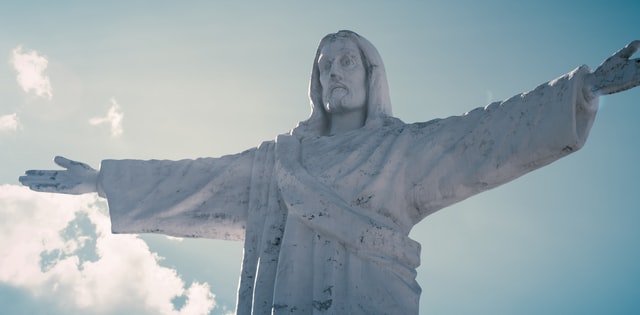 statue of Jesus with blue sky in background